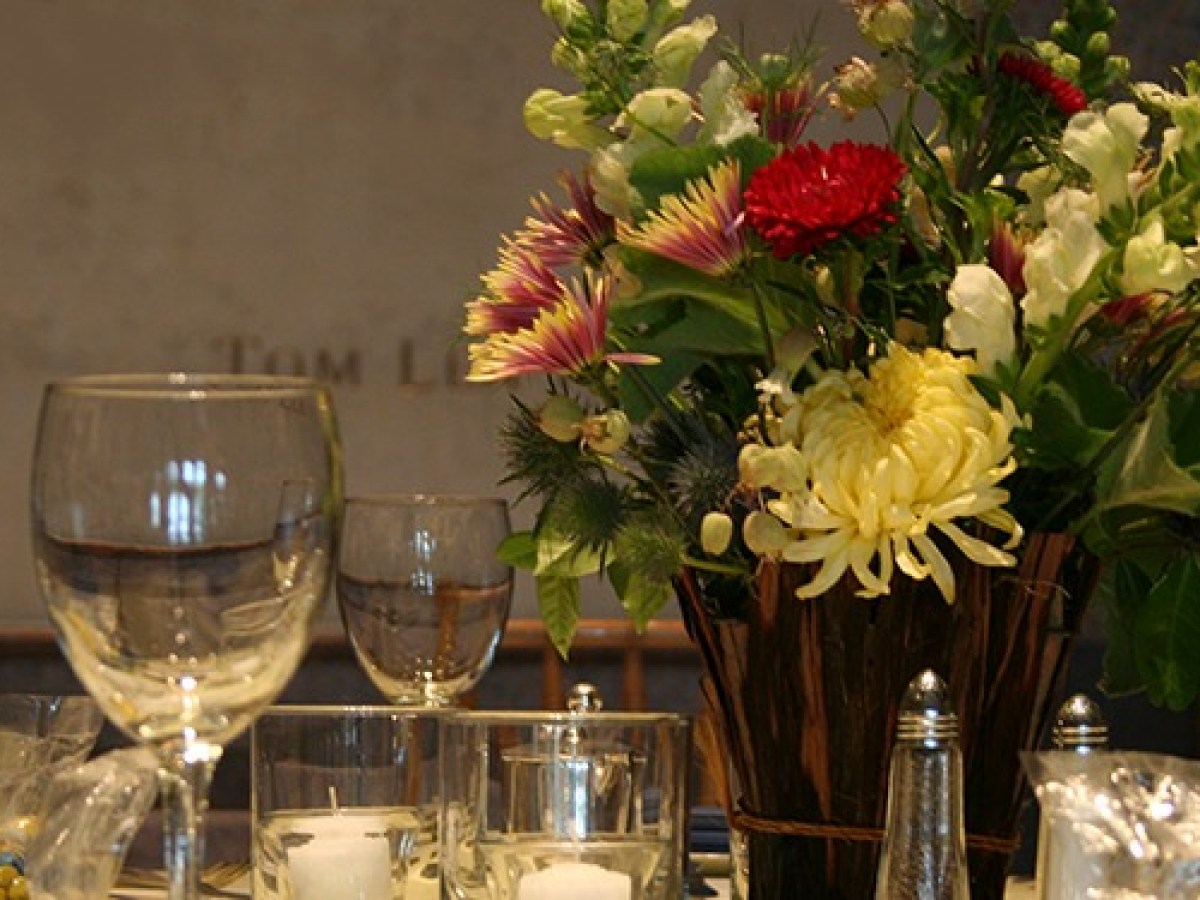 Flowers and wine glasses on top of a table