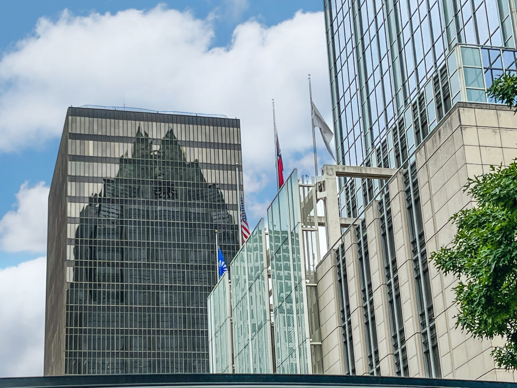 View of tall glass skyscrapers in Austin, Tx. Reflection of the Front Bank Tower on a brown glass building.