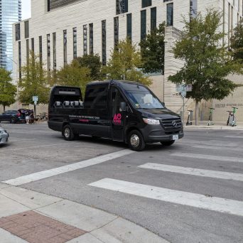 Black AO Tours Austin Panoramic Bus in front of Federal Courthouse in Austin, Texas