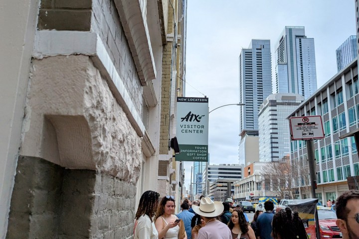 a group of people waiting for a tour outside the Austin Visitor Center