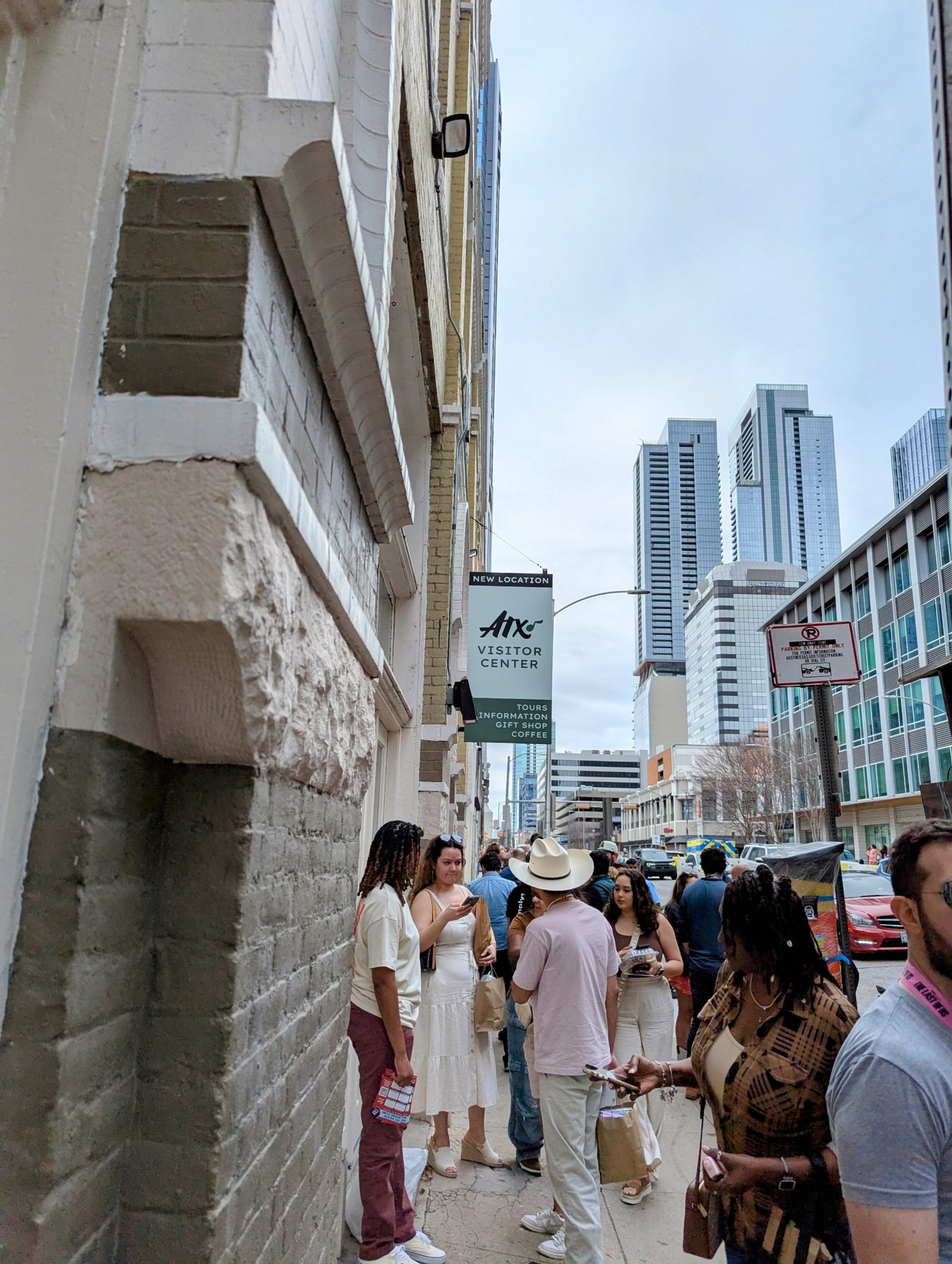 a group of people waiting for a tour outside the Austin Visitor Center